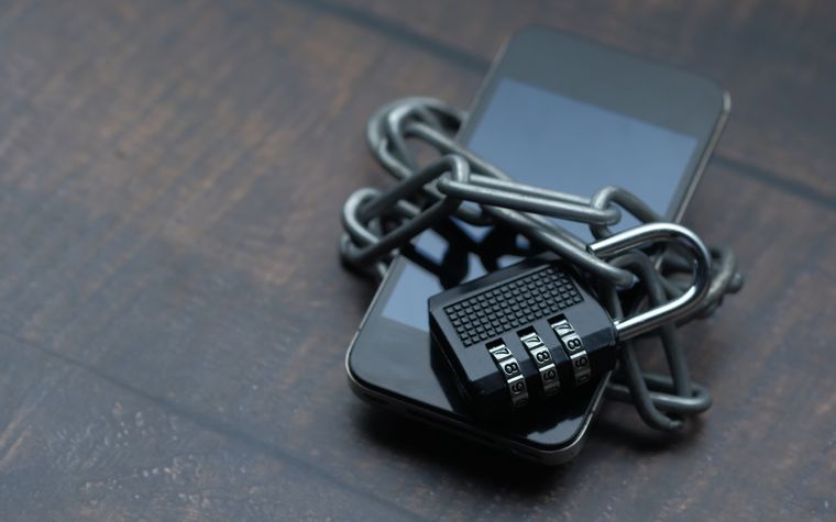 A padlock and chain securing a mobile device